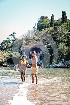 Isola Bella small island near Taormina, Sicily, Italy. Narrow path connects island to mainland Taormina beach surrounded