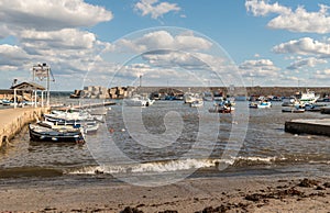 The port of Isola delle Femmine or Island of Women with fishing boats and fishermen at work, province of Palermo, Sicily, Italy