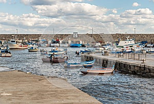 The port of Isola delle Femmine or Island of Women with fishing boats and fishermen at work, province of Palermo, Sicily, Italy