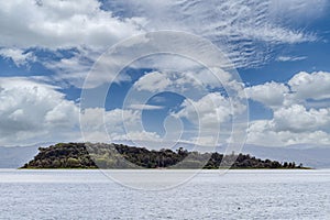 Isola Minore island in Lake Trasimeno, view from Tuoro, Perugia Italy, under a beautiful sky