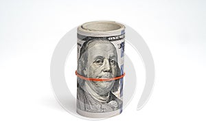 Isolate of American One hundred USD dollar rolls banknote tied with rubber bands on white background and clipping path , Dollar is