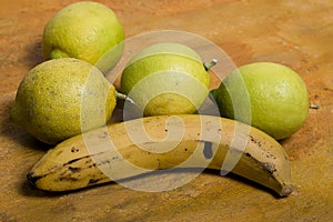 An isolate banana and four lemons