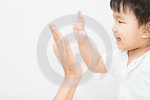 Isolate cute asian baby touch hand with mother