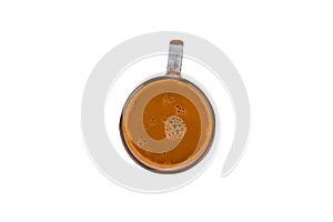 Isolate hot fresh orange Thai tea with mini bubble inside in through sight glass mug from above.