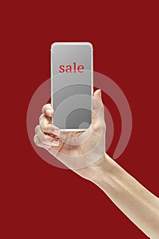 Isolate mobile phone in hand on Red background, deflate concept