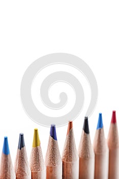 Isolate of multicolored wooden pencils. Pencils of different colors ,arranged in a rowstand out against a uniform white
