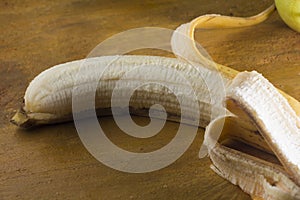 Isolate peeled banana on a yellow Background