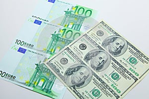 Isolated 100 EUR and 100 USD banknotes