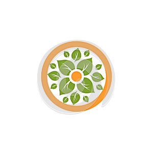 Isolated abstract round shape natural logo. Green leaves in orange circle logotype. Flower icon. Eco products sign