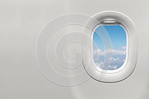 Isolated airplane window with blue sky