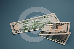 Isolated american fifty dollar bill on blue background