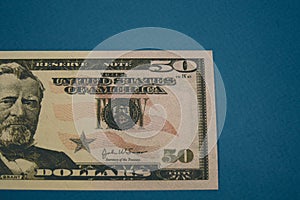 Isolated american fifty dollar bill on blue background