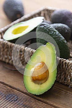 Isolated avocado on wooden table. Guacamole ingredient