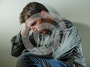 Isolated background portrait of 30s to 40s sad and depressed man looking thoughtful and worried suffering depression problem with