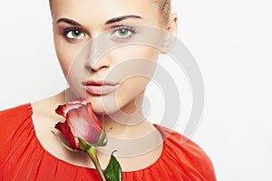 Isolated beautiful woman with flowers. girl and flower. beautiful blond girl in red dress. close-up portrait. Red rose
