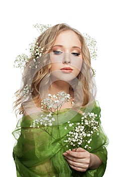 Isolated beautiful woman with long healthy blonde curly hair, make up and flowers