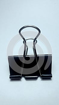 Isolated black binder clip on white background