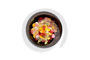 Isolated black bowl with colorful sweet candy like gummibears on white background