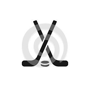 Isolated black icon of hockey stick and puck on white background. Silhouette of ice hockey icon. Logo flat design. Winter sport