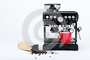 Isolated black manual coffee maker with grinder and red coffee mug and bag of freshly roasted coffee beans on white background