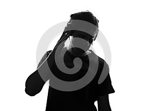 Isolated black and white portrait of a teenager listening to music in big headphones