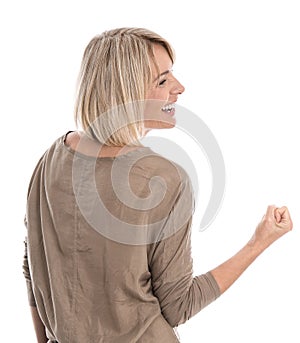 Isolated blond middle aged woman making fist: concept for success and courage.