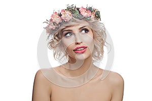 Isolated blonde woman with flowers crown on head. Pretty model with short curly haircut