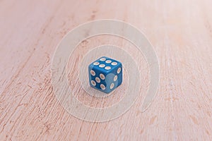 Isolated blue dice on a wooden surface with copy space. Concept of didactic and table games. the concept of table games. Board