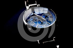 Isolated Blue Faced Chronograph Watch on Black Background