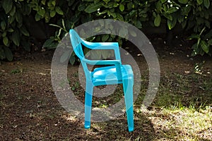 An isolated blue little chair for kids in the garden Italy, Europe
