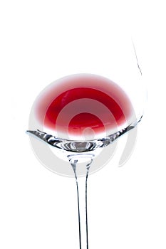 Isolated bowl and a part of stem of transparent wine glass wine with some red wine inside