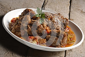 Isolated Bowl with a portion of oxtail stewed vaccinara