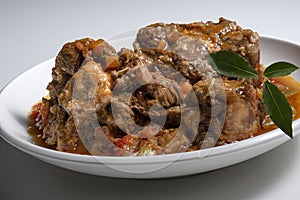 Isolated Bowl with a portion of oxtail stewed vaccinara