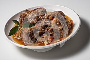 Isolated Bowl with a portion of oxtail stewed vaccinara