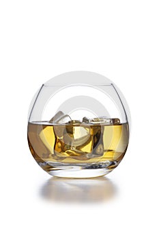 A isolated bowl style glass of whisky and ice, shot on white