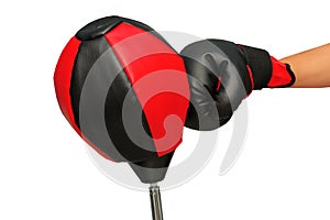 Right hand with black and red boxing grove punch to the upholstering black and red punching ball bag until the tilt.