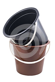 Isolated braun and black plastic buckets photo