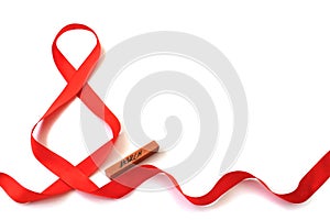 Isolated bright red satin ribbon in the shape of the figure 8 and a wooden bar with the inscription `March` on a white backgroun