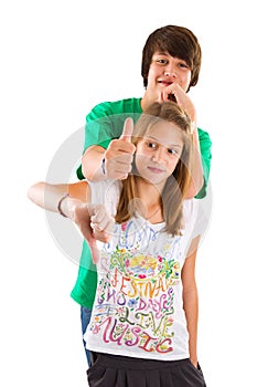 Isolated brother and sister thumbs up and down