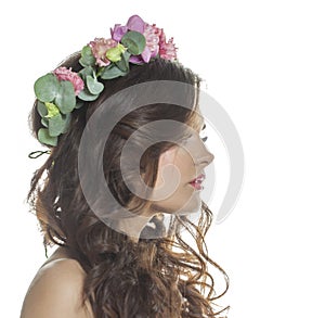 Isolated brunette woman profile with fresh flower on her head. Spring, cosmetic, beauty, skin care and hair care concept