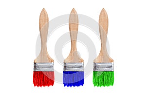 Isolated brushes. Three brushes with red, blue and green paint are isolated on a white background.