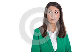 Isolated business woman in green looking doubtful sideways to te photo