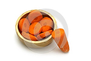 Isolated carrot sliced in the wooden bowl on white background with clipping path