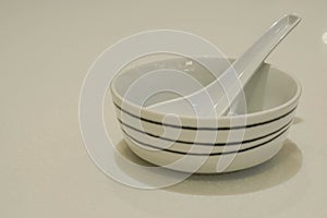 Isolated ceramic bowl with spoon for hot soup