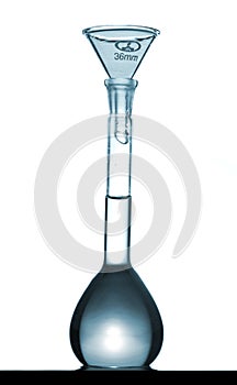 Isolated chemical volumetric flask on table with funnel