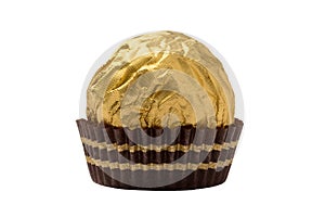 Isolated chocolate candy wrapped in golden foil