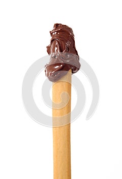 Isolated chocolate cream on breadstick in white background