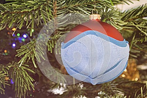 Isolated Christmas ball wearing face mask