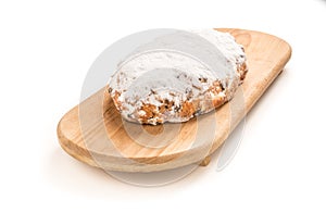 Isolated Christmas stollen on a wooden board