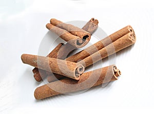 Isolated cinnamon sticks lying on white dish